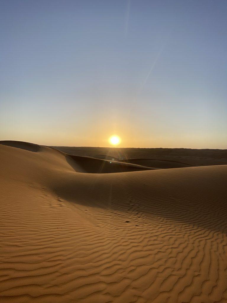 Sunset over the Sahara Desert dunes