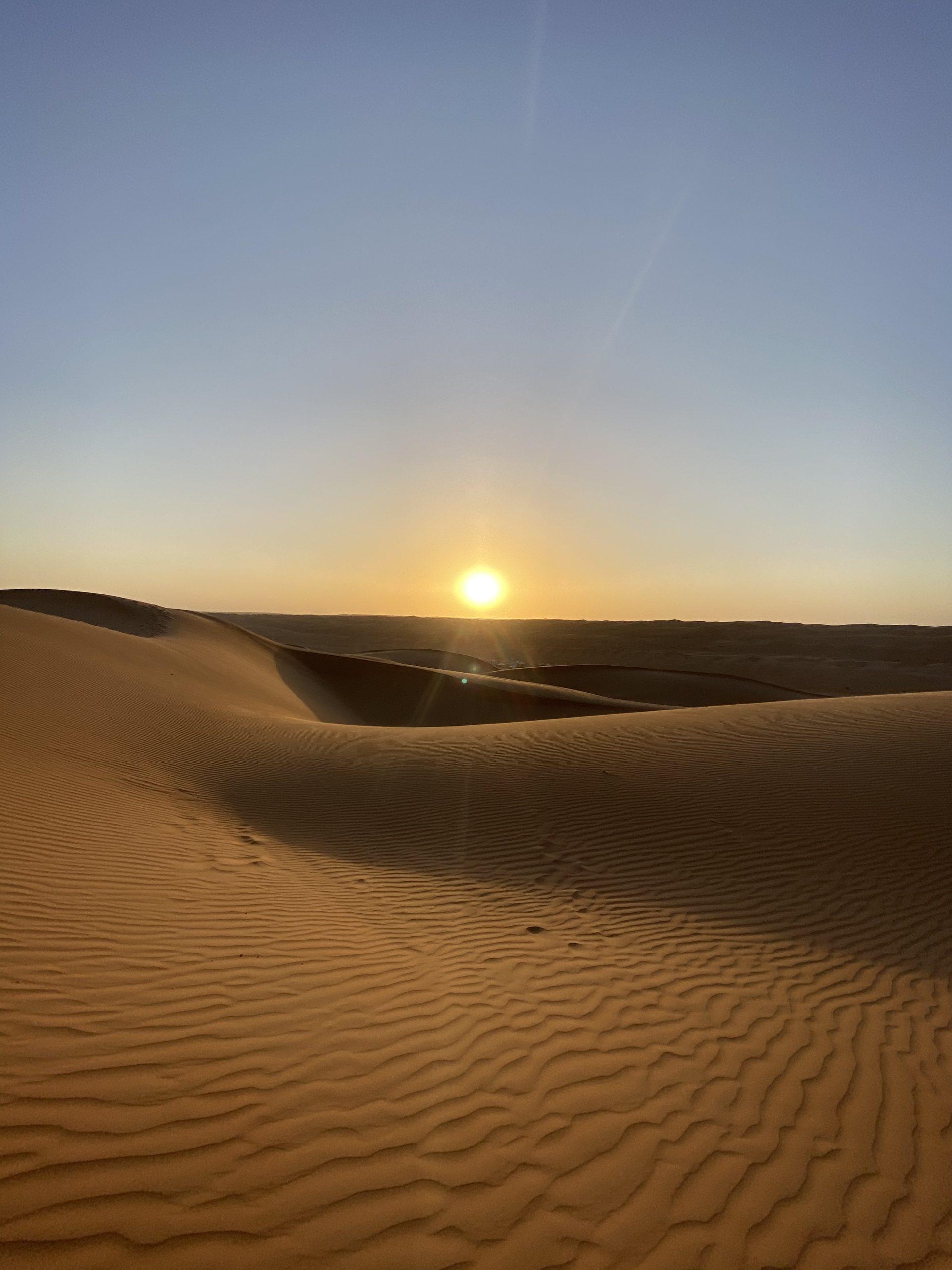 Sunset over the Sahara Desert dunes